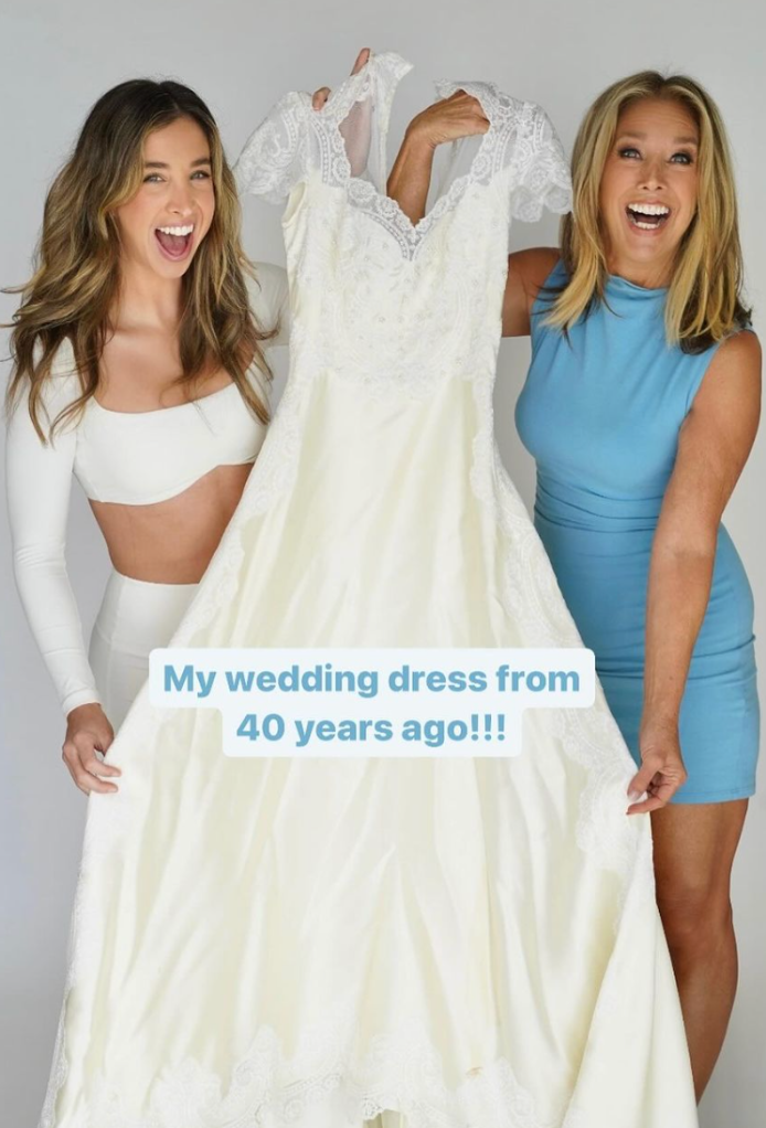 Denise Austin and Katie Austin pose with Denise's wedding dress, 2024